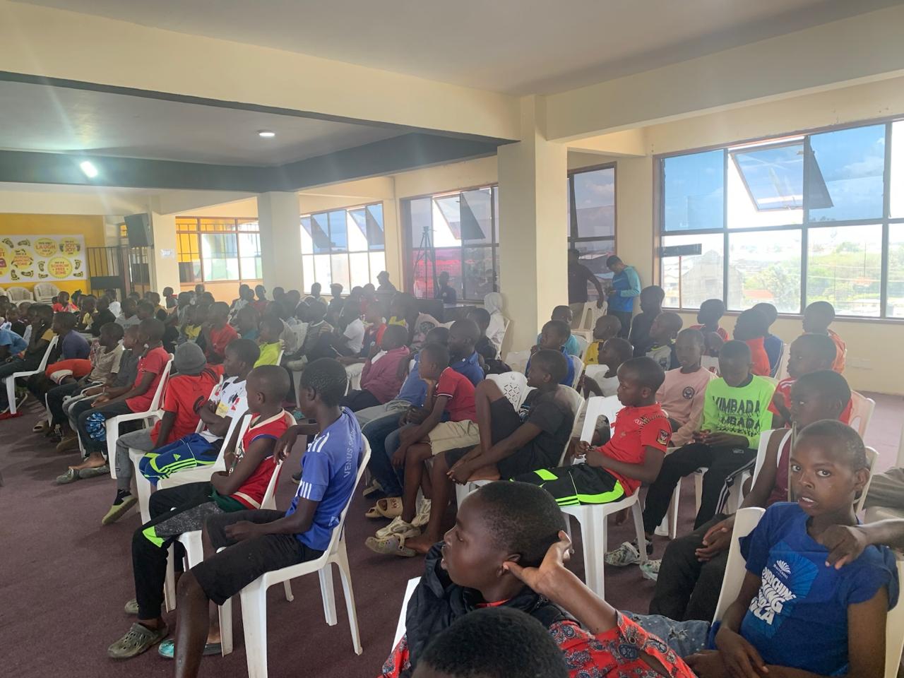 Teenagers seated and attentively listening at camp